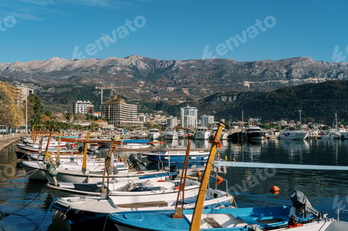 Preview: Motorboats are moored along the pier overlooking the high-rise buildings on the shore