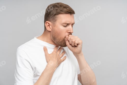 Preview: Portrait of man has bad cough, sore throat,chest pain on grey background, bronchitis, tracheitis.