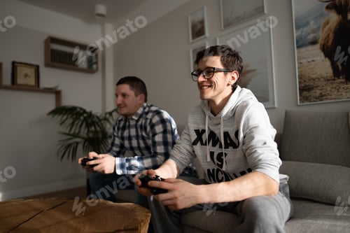 Preview: Two Men Playing Video Games on a Couch