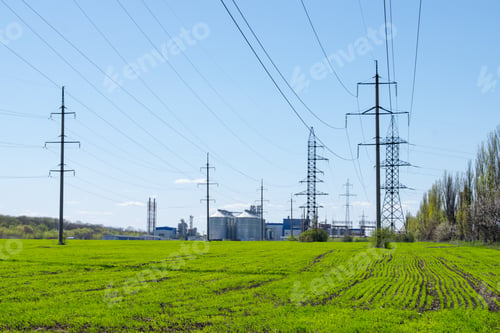 Preview: Modern soybean processing plant, agricultural Silos against green field and blue sky. Storage and