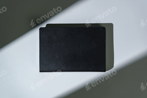 Preview: Black notepad with hard cover on gray background
