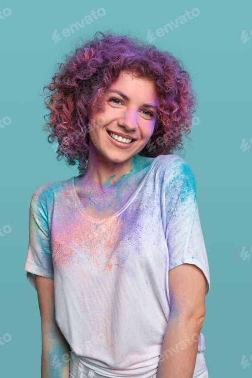 Preview: Content woman in Holi powder in studio