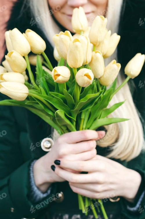 Preview: Woman Holds Bouquet of Yellow Tulips