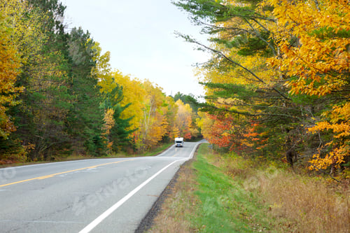 Preview: Camper drives along a Minnesota highway lined with trees in autumn color