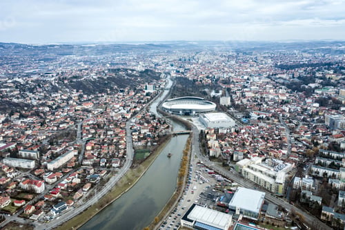 Preview: Aerial above view of river crossing the city. Drone shot of Cluj Napoca, Romania