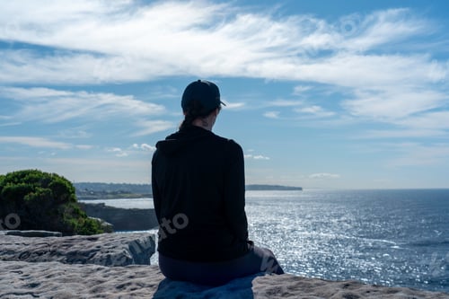 Preview: Woman sitting on cliff edge alone, enjoying view lifestyle travel adventure outdoor hiking views
