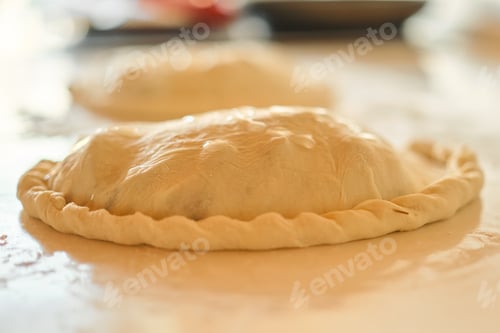 Preview: calzone ready to bake standing on the kitchen table
