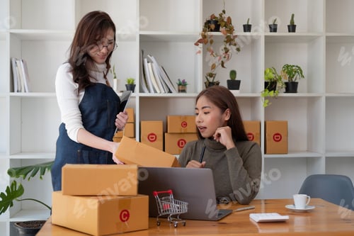 Preview: Two asian woman working together for SME project. Young Owner people startup for Business Online