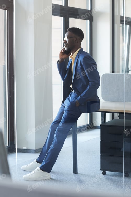 Preview: Elegant African Businessman Speaking by Smartphone