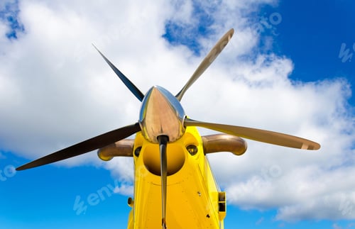 Preview: Closeup of an agricultural aircraft, yellow airplane on the cloudy sky background
