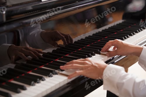 Preview: Close up of a pianist's hands, playing on a grand piano.