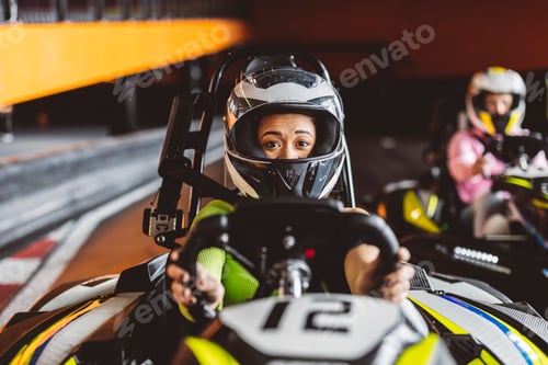 Preview: Hispanic latin woman with helmet holding kart steering wheel