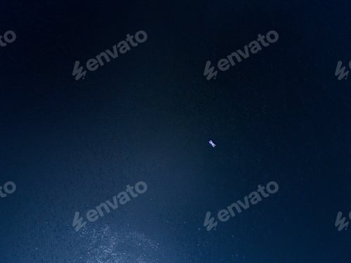 Preview: Aerial top down view of an unidentified man on the inflatable mattress relax and enjoys sun on deep