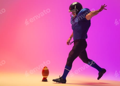 Preview: Caucasian male american football player kicking ball with neon pink lighting