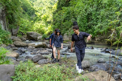 Preview: group of young asian trekking and hiking on rocky river stream
