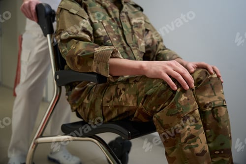 Preview: Healthcare worker transporting hospitalized military man along corridor