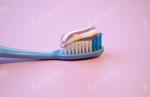Preview: toothbrush with toothpaste on pink background,