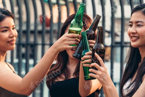 Preview: Group of Asian girl celebrating with toasting beer bottle together