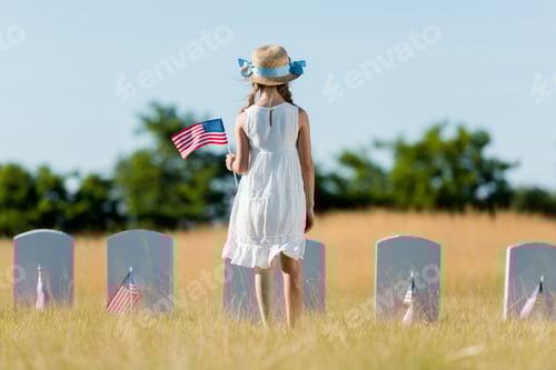 Preview: Child Holding American Flag at Grave Site