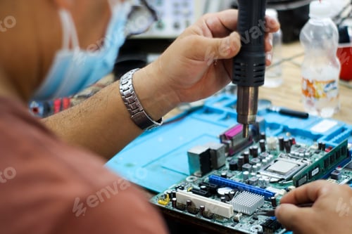 Preview: Hispanic man repairing the computer motherboard