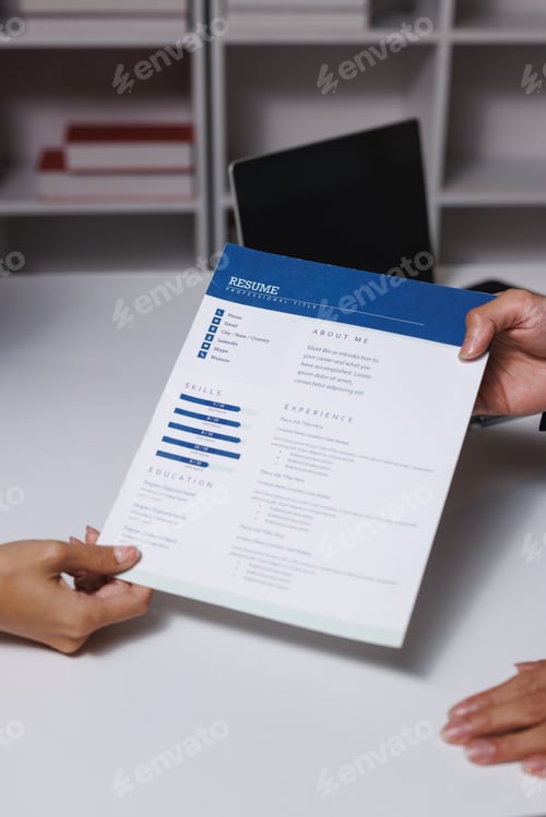 Preview: Applicant passing resume document during job interview
