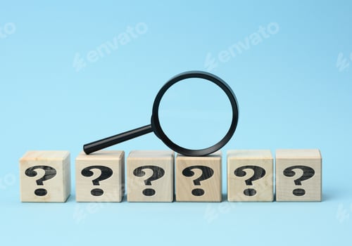 Preview: Wooden cubes with question marks and a magnifying glass on a blue background