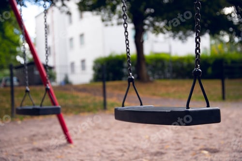 Preview: Black swing with red posts in a playground