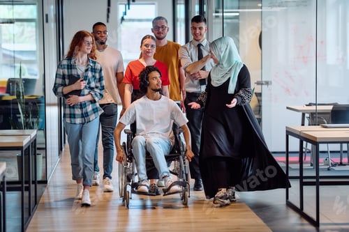 Preview: A diverse group of young business people congregates within a modern startup's glass-enclosed office