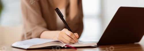 Preview: Caucasian young woman talking on phone writing notes