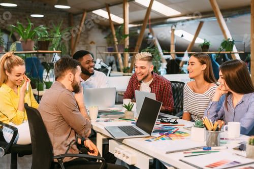 Preview: Creative start-up team discussing ideas in modern office