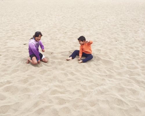 Preview: Two Children Playfully Interacting on the Beach