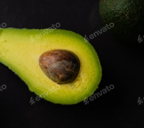 Preview: Micro close up of avocado with water drops and copy space on black background