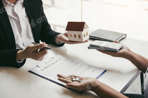 Preview: Hand of real estate agent passes the key to new homeowners in office with buyer house concept.