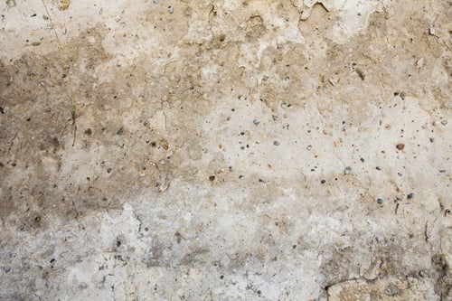Preview: Textured surface of an old, weathered wall with stains and rough patches in neutral tones