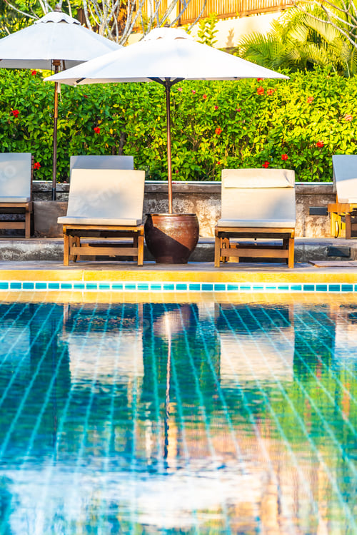 Preview: Umbrella and chair around swimming pool in hotel resort neary se