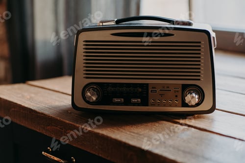 Preview: Radio broadcasting music. Old retro radio in light room on wooden table. Vintage color.