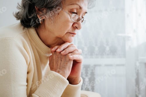 Preview: Loneliness of elderly, sadness, depression, mental female health concept. Side view of senior mature