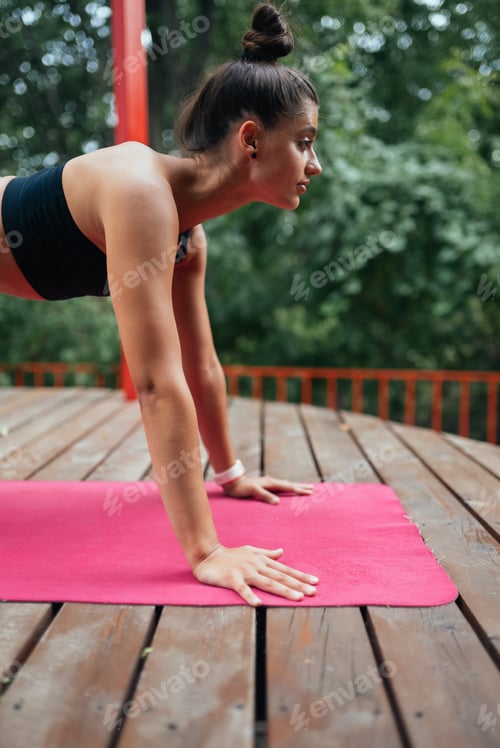 Preview: A young woman in doing yoga in the yard