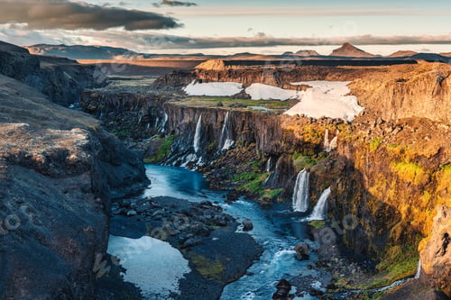 Preview: Sunset over Sigoldugljufur with tiny waterfall flowing in canyon on Icelandic Highlands