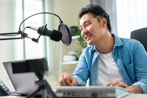 Preview: Asian attractive audio DJ man speaks into microphone to broadcasting.