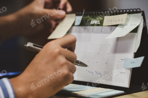 Preview: Close up of businessman checking memo and planning schedule on calendar planner