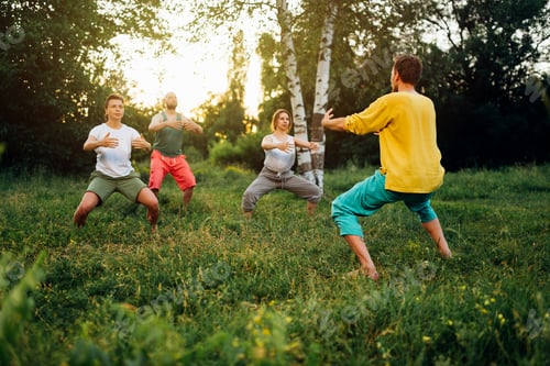 Preview: Trainer explains how to do manu stance exercise. Group learning qigong in nature.