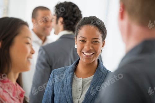 Preview: An office in the city. A multi ethnic team standing together in a group.