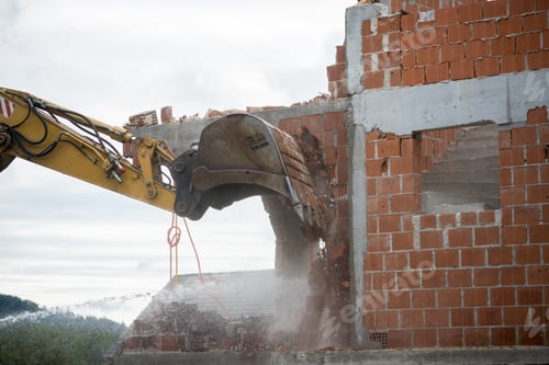 Preview: Backhoe demolishing a brick house