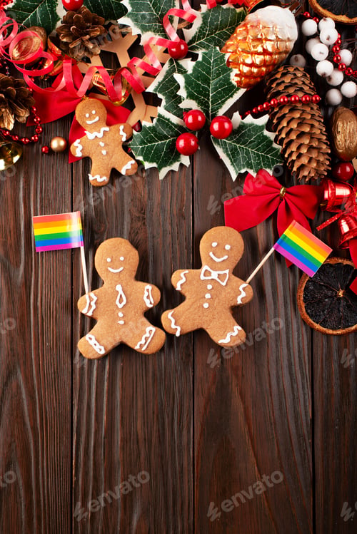 Preview: Christmas background of gingerbread cookie men with rainbow flags on wooden table