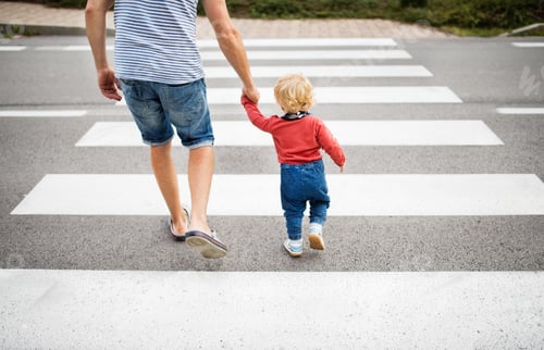 Preview: Father with little boy crossing the road on crosswalk.