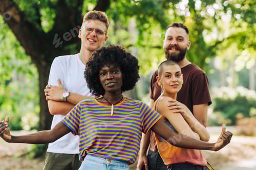 Preview: Interracial gang is posing in city park and smiling at the camera.