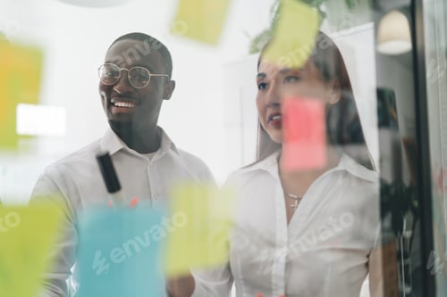 Preview: Young multiracial coworkers brainstorming in modern workspace