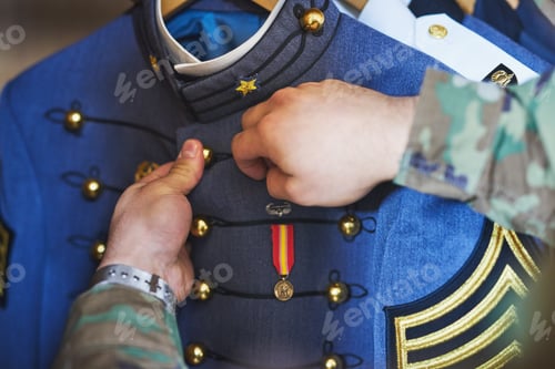 Preview: Keep your heroism close to your heart. Cropped shot of a soldier pinning a medal to his jacket.