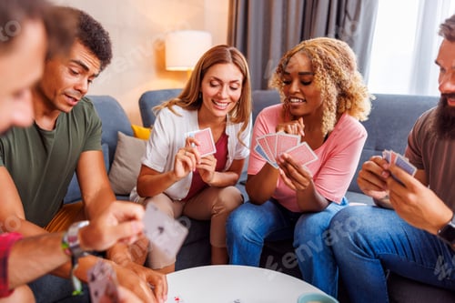 Preview: Friends having fun playing cards at home